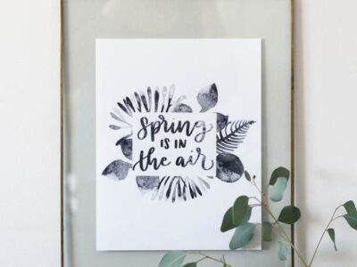 spring is in the air black watercolor printable handlettered in floating frame with vase of eucalyptus