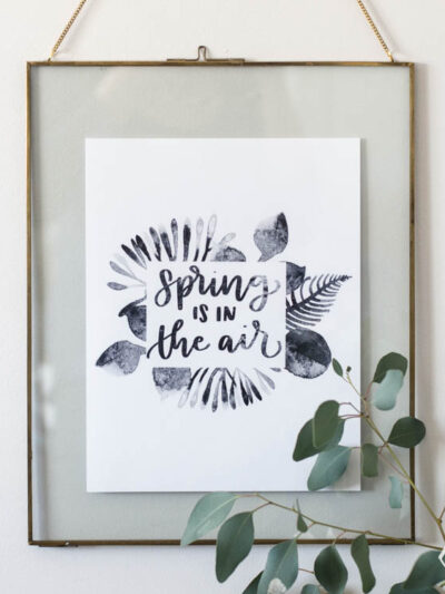 spring is in the air black watercolor printable handlettered in floating frame with vase of eucalyptus