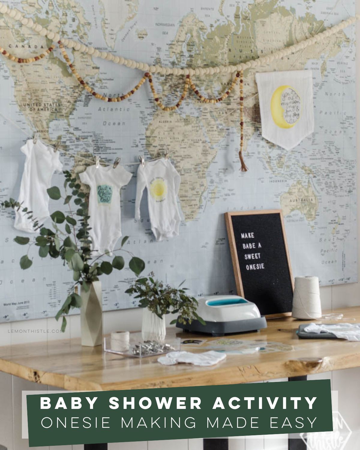 Baby shower activity- simple onesie making station, image of station set up with easy press iron, onesies hung, and letterboard sign