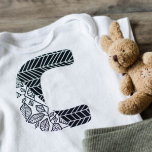 Onesie with large C in two designs of patterned iron on- simple cricut diy