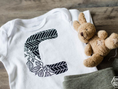 Onesie with large C in two designs of patterned iron on- simple cricut diy