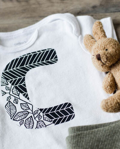 Onesie with large C in two designs of patterned iron on- simple cricut diy
