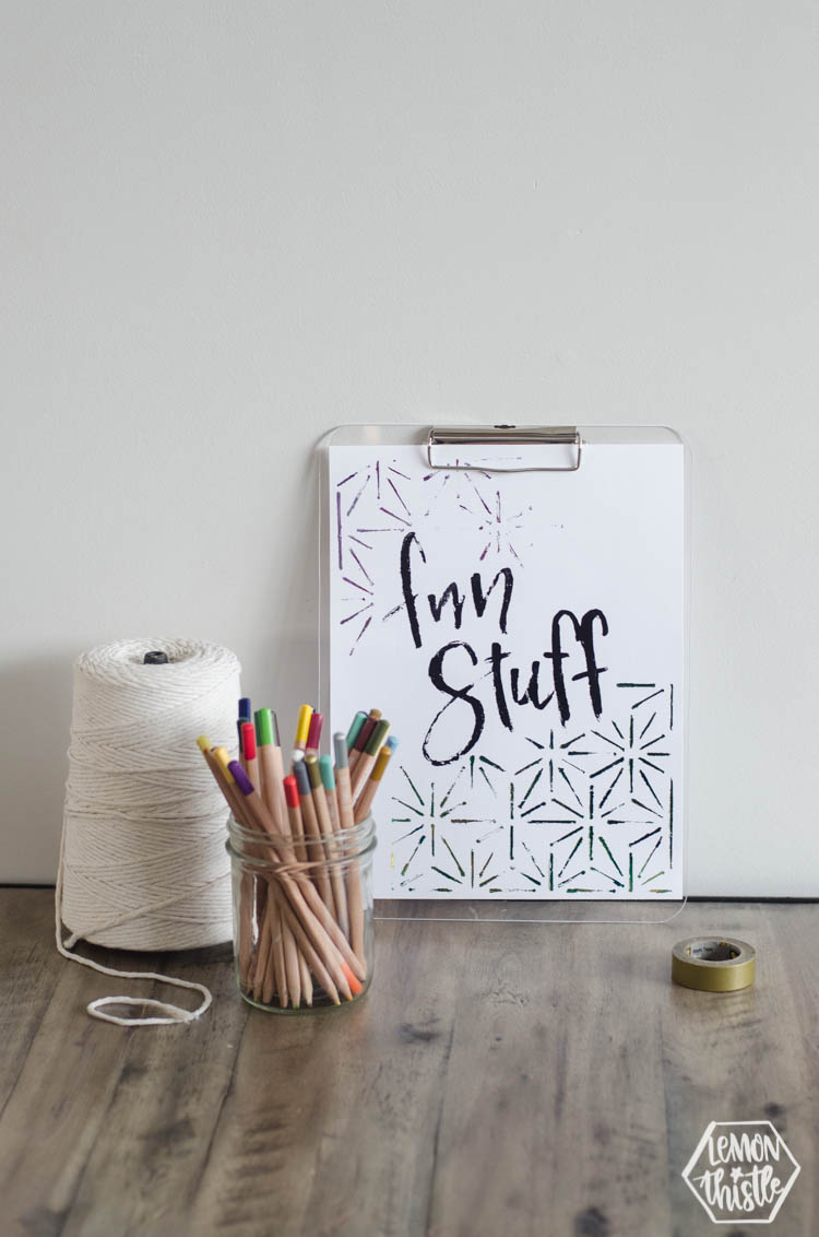 art station with macrame string, pencil crayons and clipboard with 'fun stuff' quote in black foil