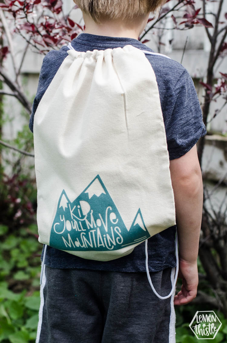 Kid, You'll move mountains drawstring bag on kids back