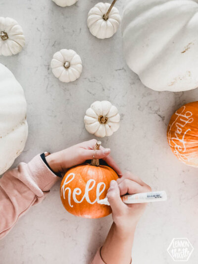 hand lettering with paint marker on pumpkins