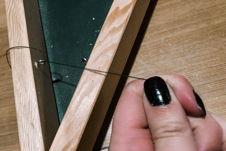 Eye hooks into wood frame