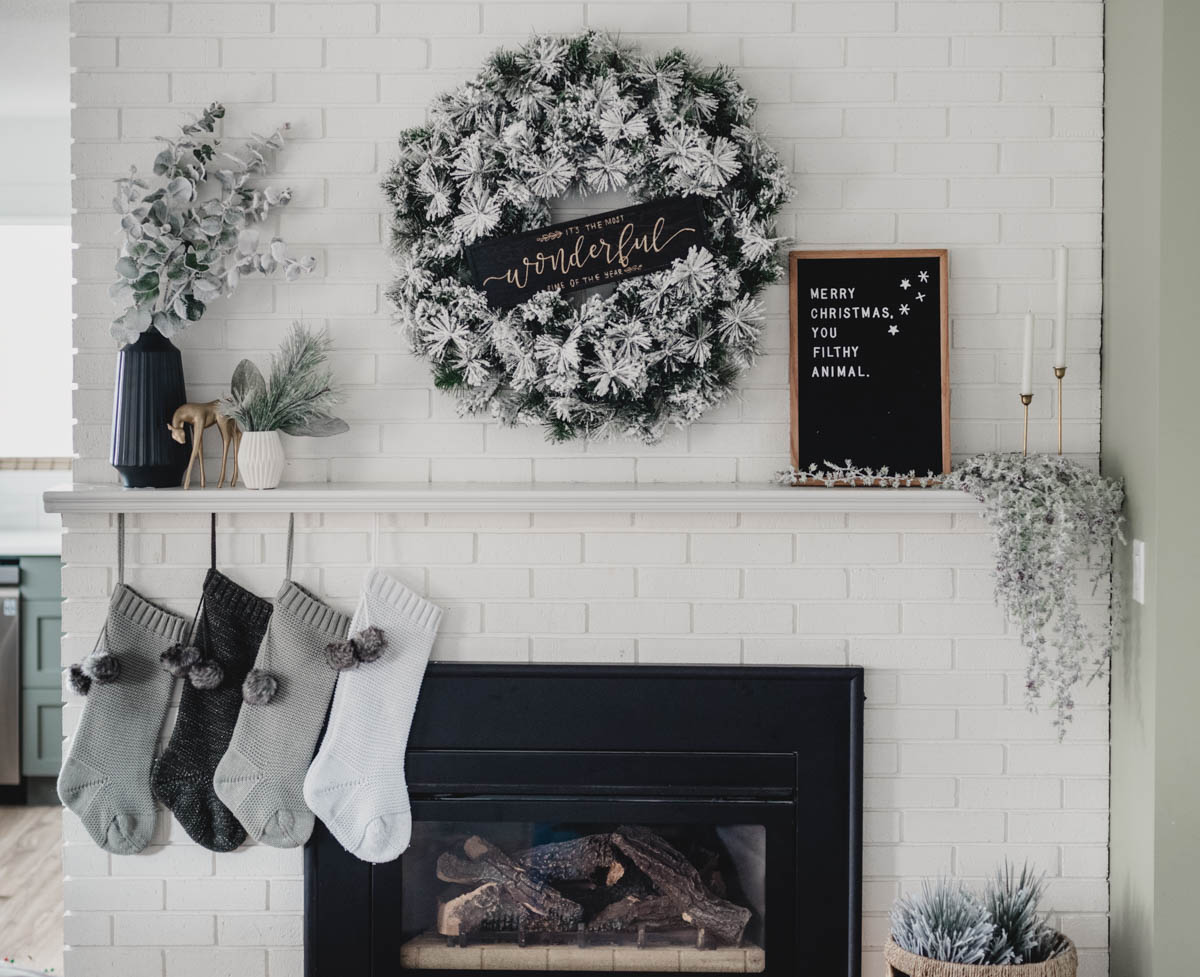 Modern holiday mantel with flocked greenery