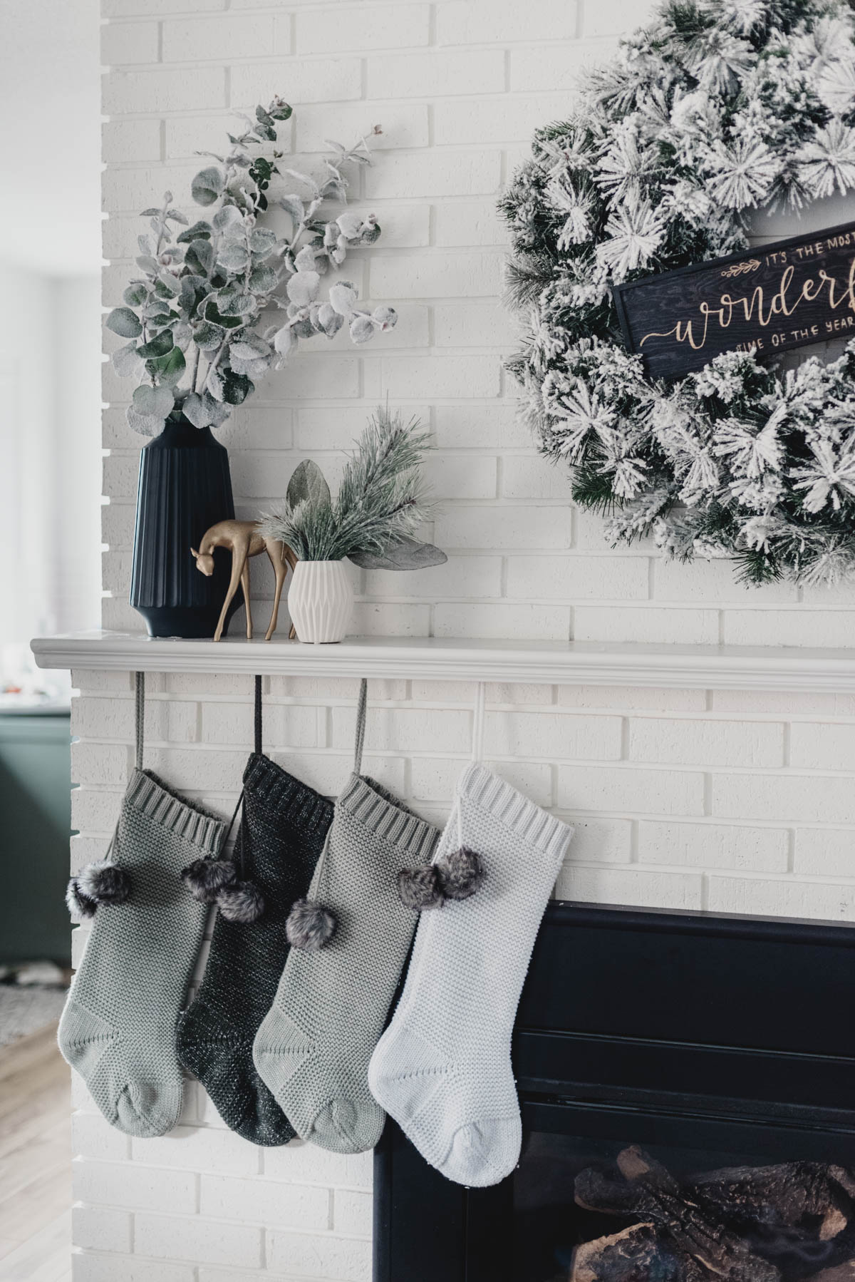 Modern holiday mantel with flocked greenery, black and white! And a letterboard ;)