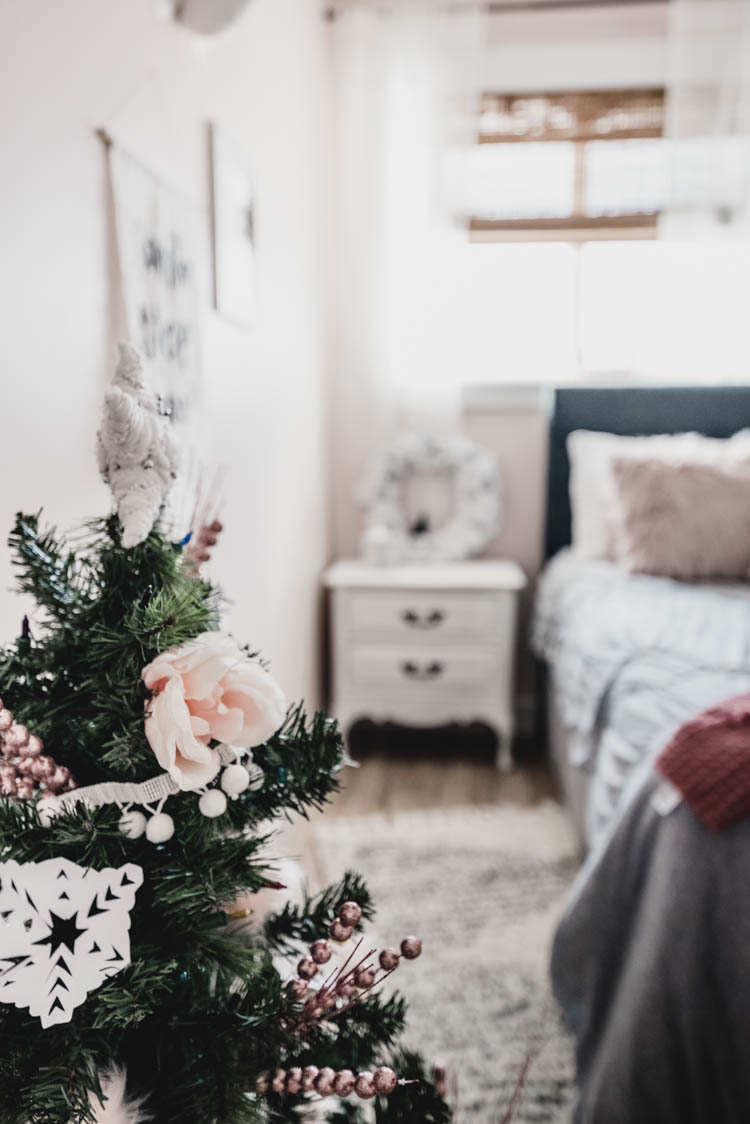 so pretty for a little girl! pink and white holiday decor. Girls bedroom christmas room tour with flowers on the tree