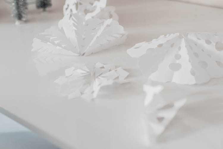 Cutting out paper snowflakes for Christmas