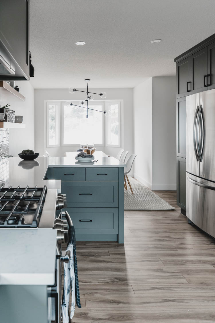 Love how they didn't put pendants over the peninsula to show off that dining room light! So modern!