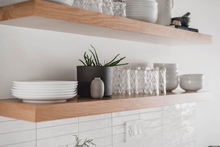 Pretty glasses and plain white dishes for practical but pretty open shelving in the kitchen