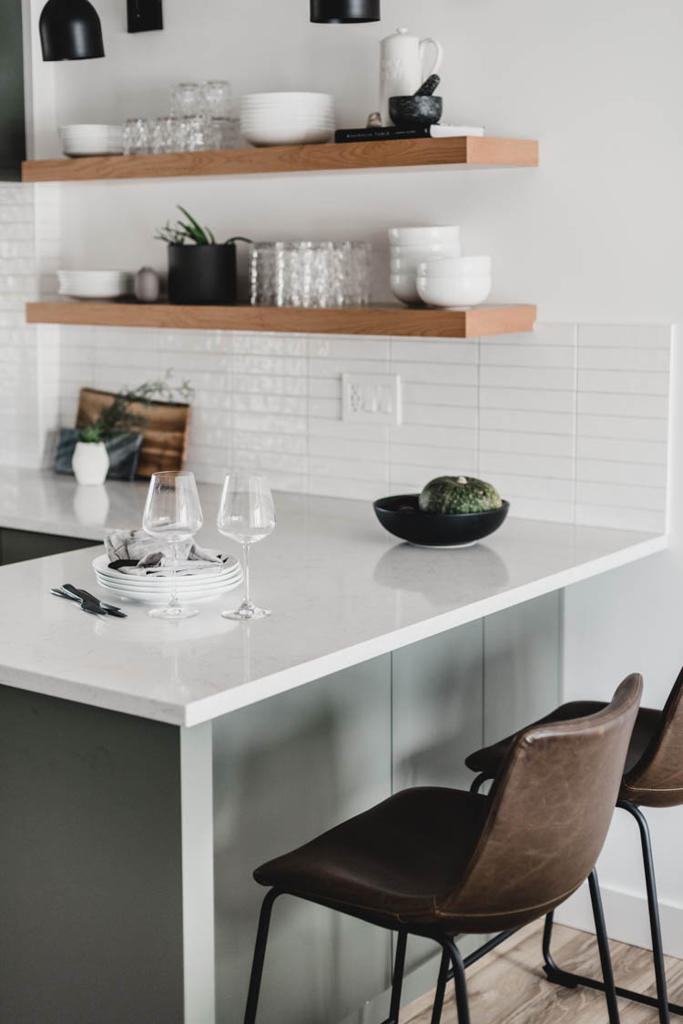 small peninsula with open shelving in kitchen