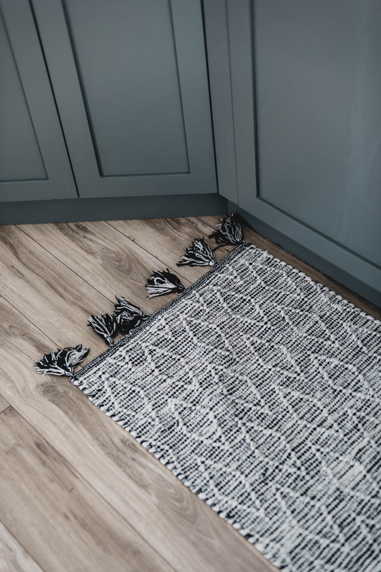 Light wood floors against green cabinets