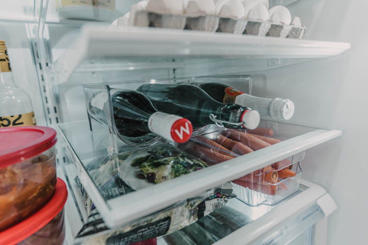 Using a wine bottle holder to free up tall shelf space in fridge