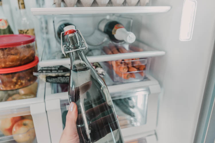 Using a wine bottle holder to free up tall shelf space in fridge