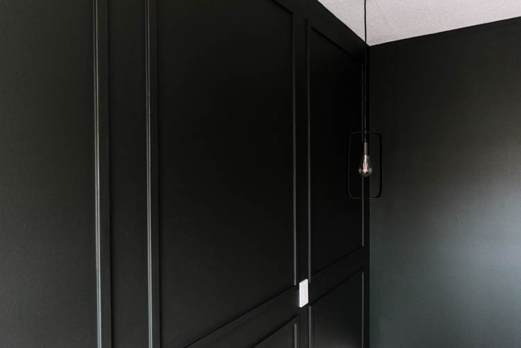 DIY Moulding Wall tips and video tutorial- black moulding wall picture frame style with hanging black pendant light in front