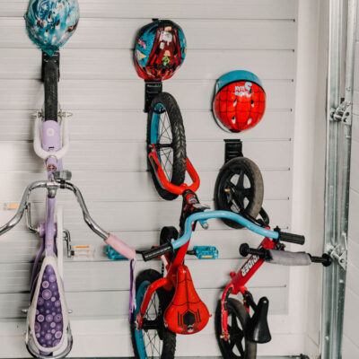 The best way to store kids bikes! Bike hooks with small hooks for helmet- slat wall storage