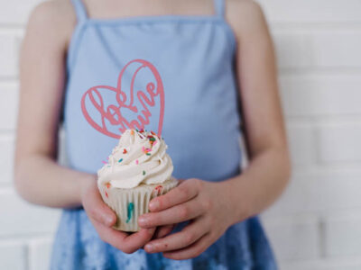 Girl holding cupcake with be mine cake topper