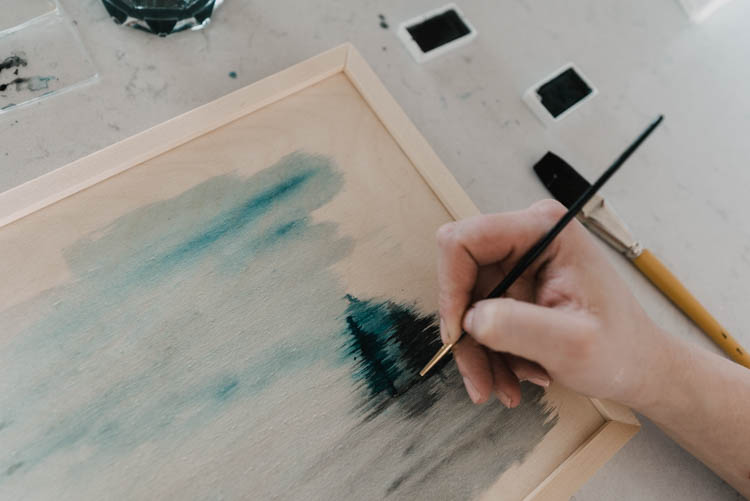 Adding trees to a watercolor wash for a foggy trees painting