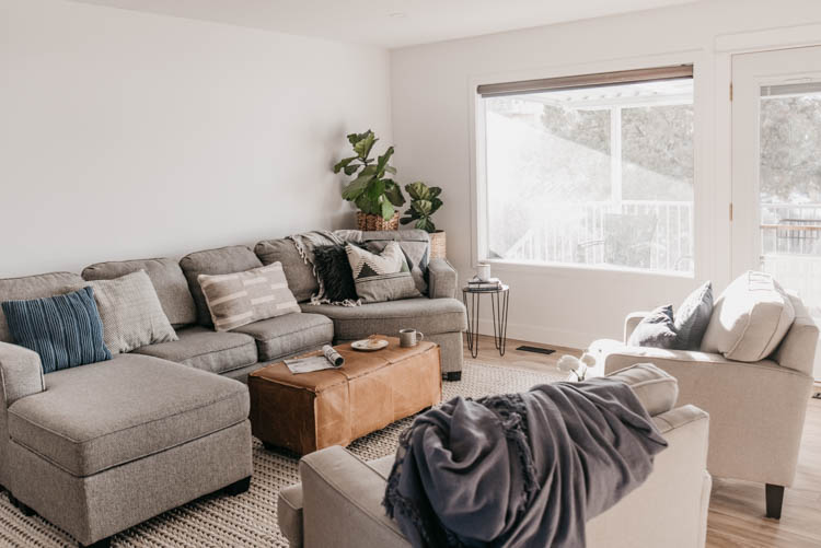 living room progress! love the cozy cushions and that leather ottoman