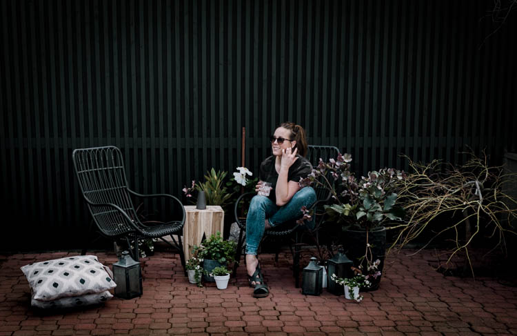 Modern brick patio- love the black wicker chairs!