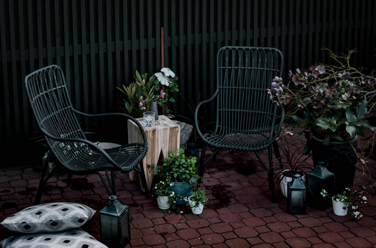 Modern brick patio- love the black wicker chairs!
