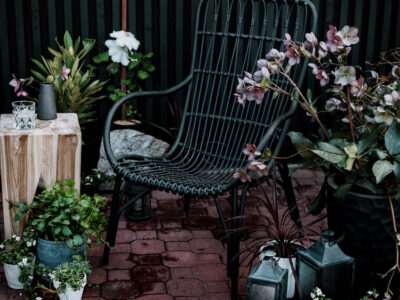 Modern brick patio- love the black wicker chairs!