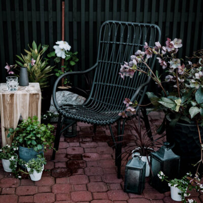 Modern brick patio- love the black wicker chairs!