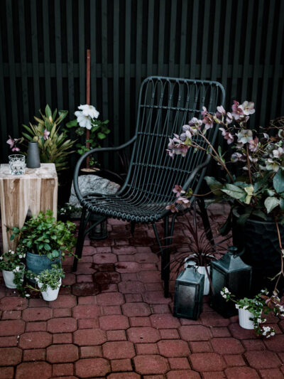 Modern brick patio- love the black wicker chairs!