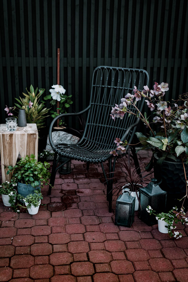 Modern brick patio- love the black wicker chairs!