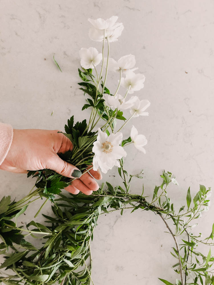 Arranging flowers for a fresh wreath