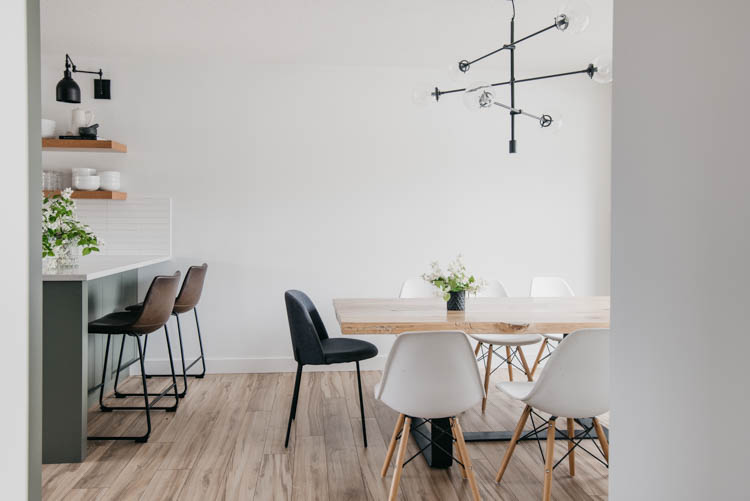 Love this open concept dining room and kitchen- the modern elements and one flooring tie it together