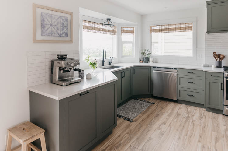 Beautiful green kitchen with summer floral arrangements
