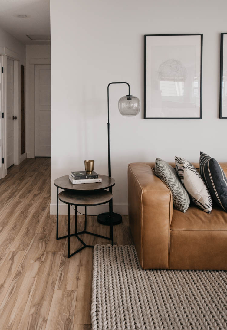 Modern family home with a leather sectional and tree print art!