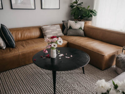 modern leather sectional with round coffee table for a family friendly home