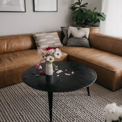 modern leather sectional with round coffee table for a family friendly home