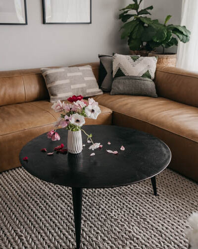 modern leather sectional with round coffee table for a family friendly home