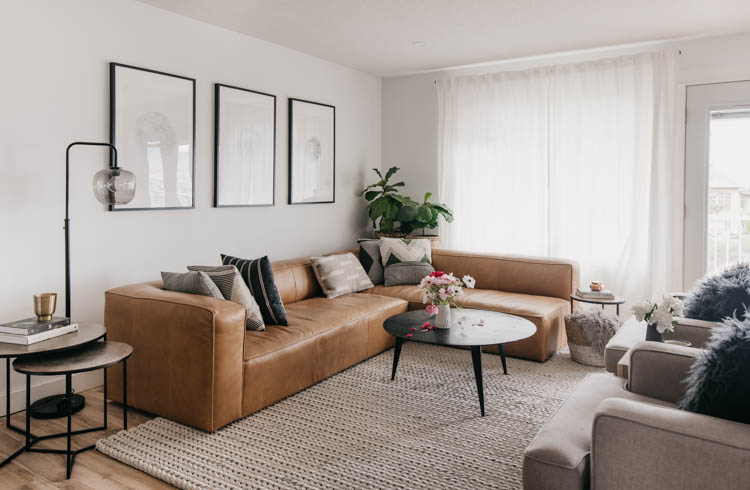 modern leather sectional with round coffee table for a family friendly home