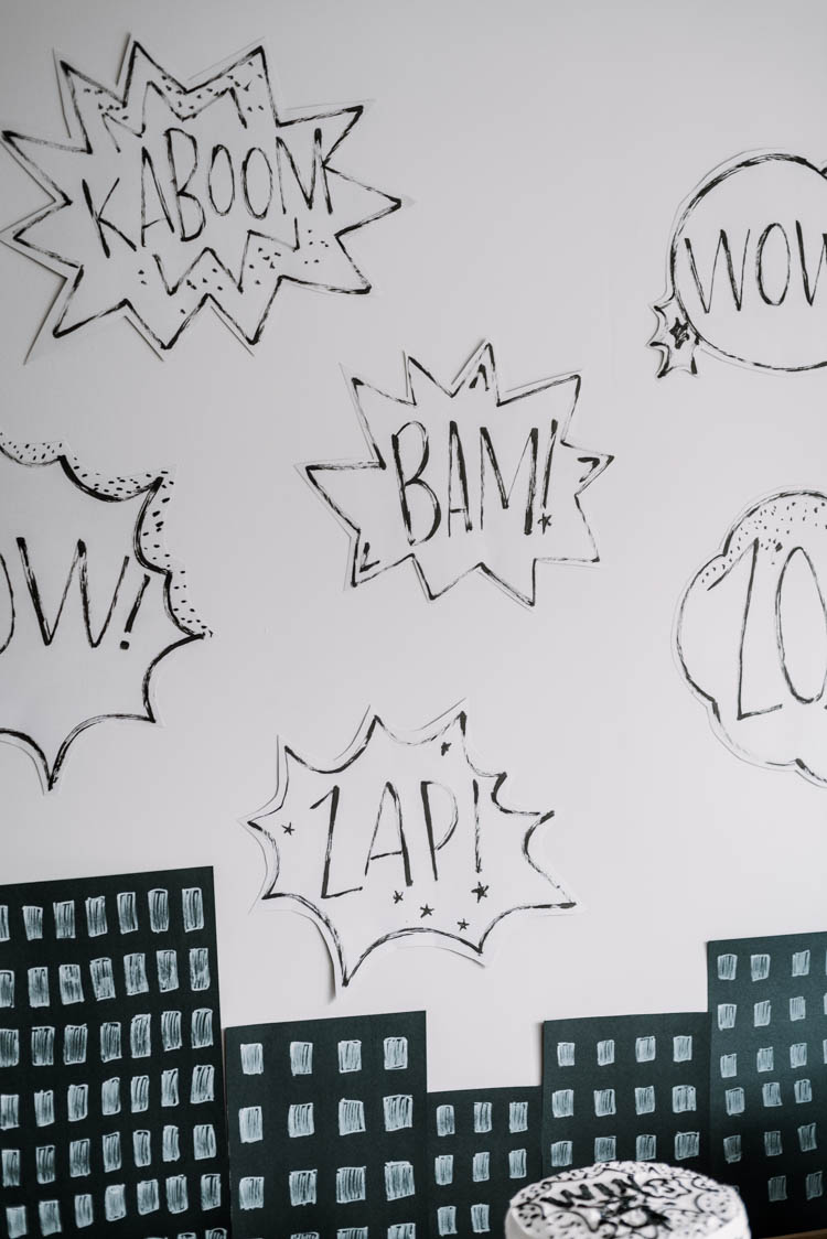 Cartoon word bubbles for a superhero birthday party- such a simple idea for a party backdrop!