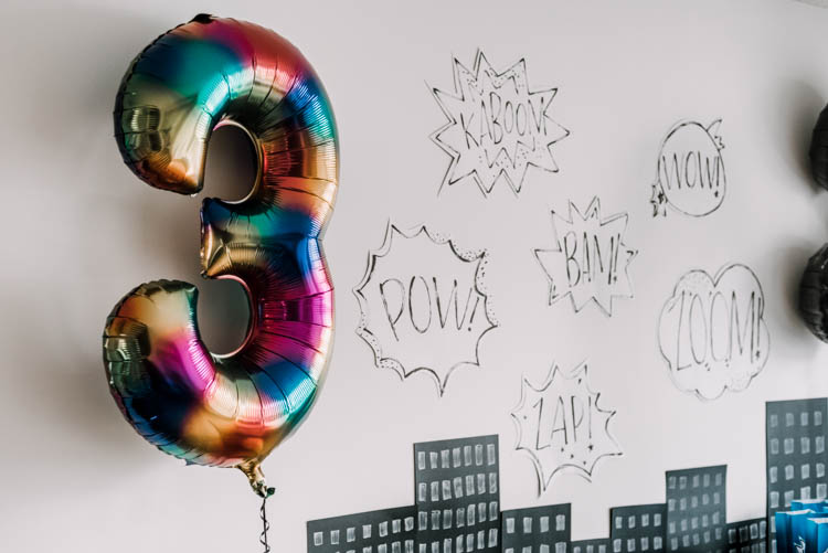 Cartoon word bubbles for a superhero birthday party- such a simple idea for a party backdrop!