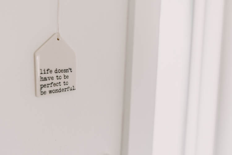 Little ceramic quote hung by the front door