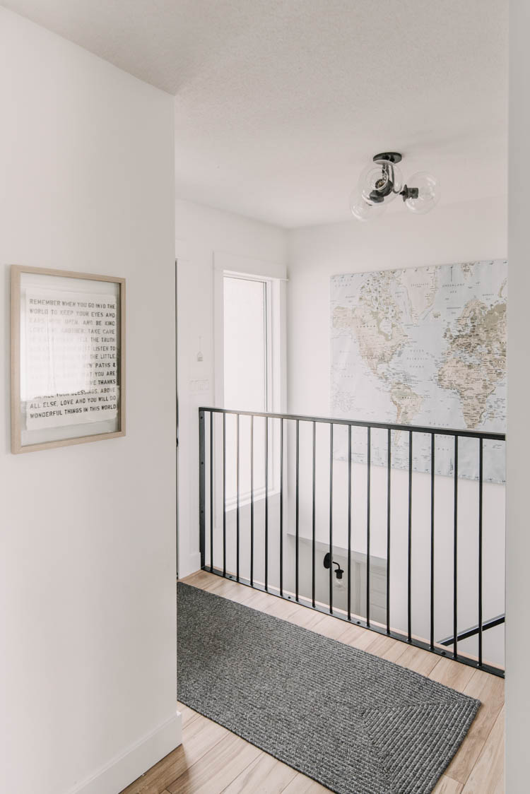 Modern metal stair railing in a small entryway makeover