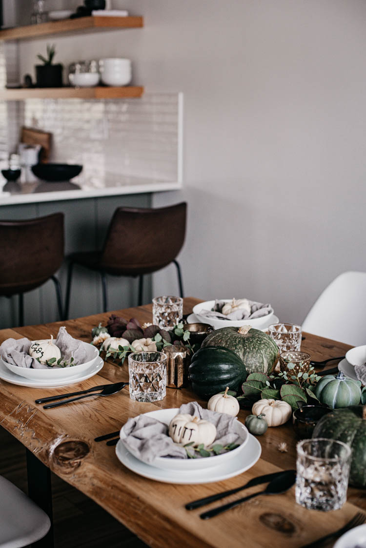 Beautiful green autumn tablescape with hand lettered pumpkin place cards for thanksgiving
