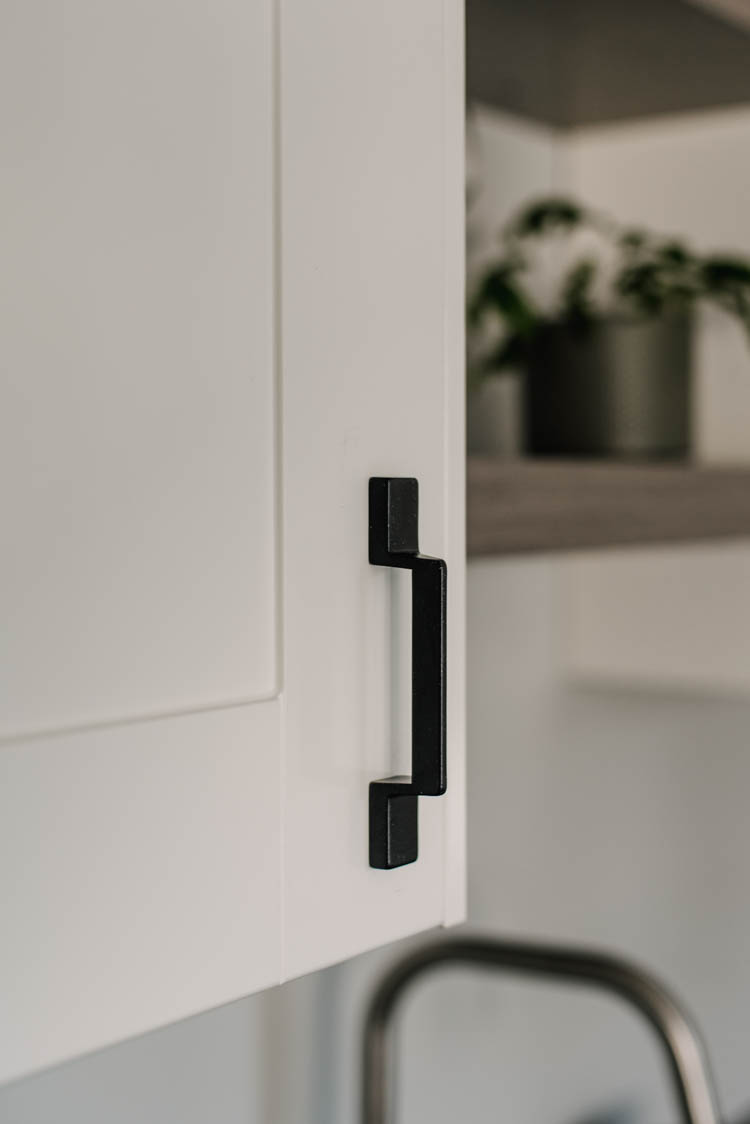 geometric black cabinet pulls on white shaker fronts
