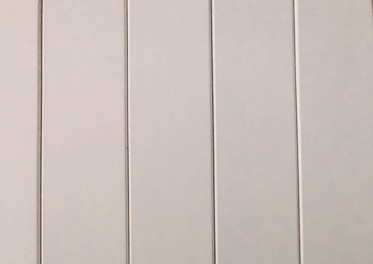 Finishing a vertical shiplap wall- how we fill nail holes and edges