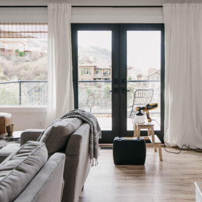 How we painted our patio doors black (including masking off the living room!) and the before and after- it makes SUCH a big difference in the feel of the space