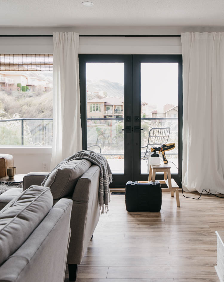 How we painted our patio doors black (including masking off the living room!) and the before and after- it makes SUCH a big difference in the feel of the space