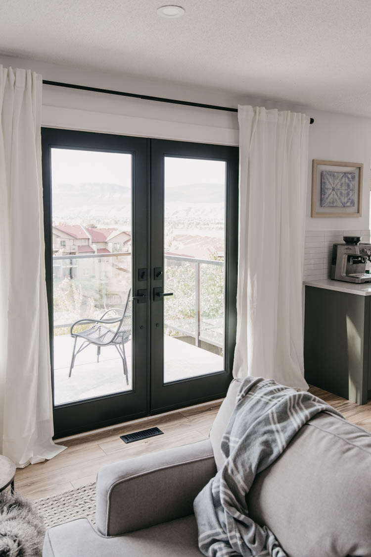 Black patio doors in a white room