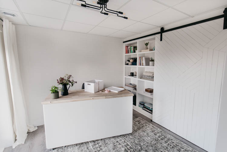 DIY built in shelving with barn door overtop for a studio 